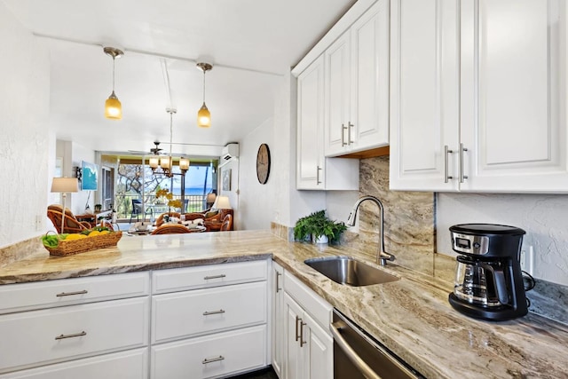 kitchen with pendant lighting, backsplash, white cabinetry, and sink