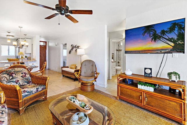 living room featuring ceiling fan with notable chandelier