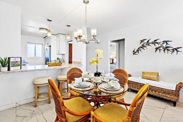 dining area with an inviting chandelier