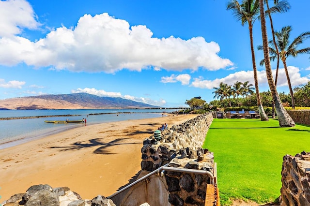 view of water feature with a mountain view and a beach view