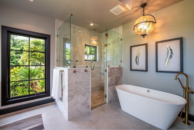 bathroom featuring separate shower and tub