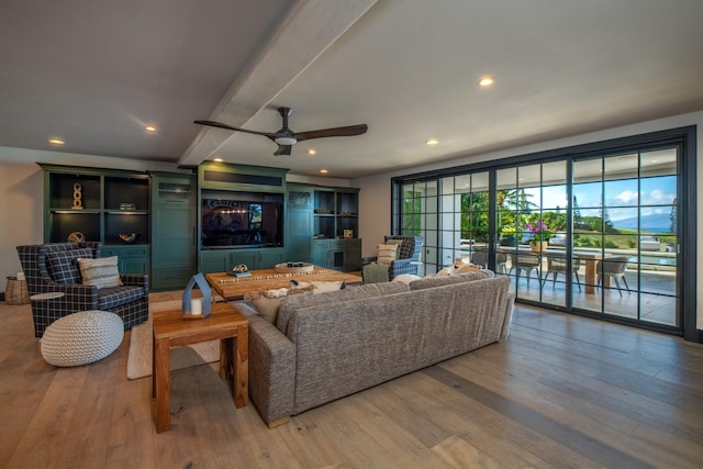 living room featuring ceiling fan and hardwood / wood-style flooring