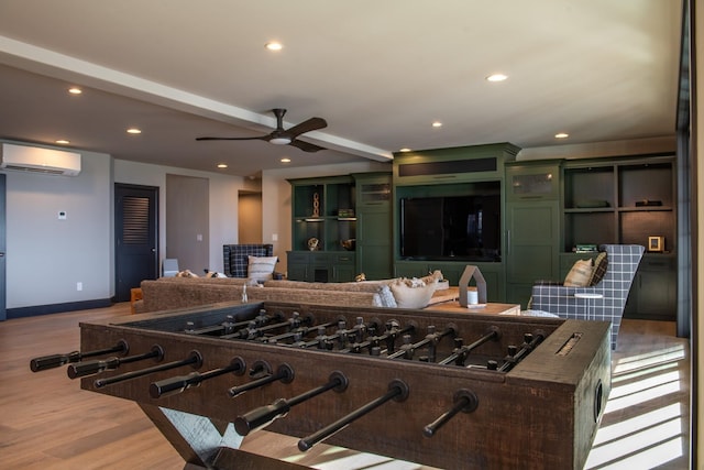 interior space with green cabinets, light hardwood / wood-style flooring, ceiling fan, a kitchen island, and a wall unit AC