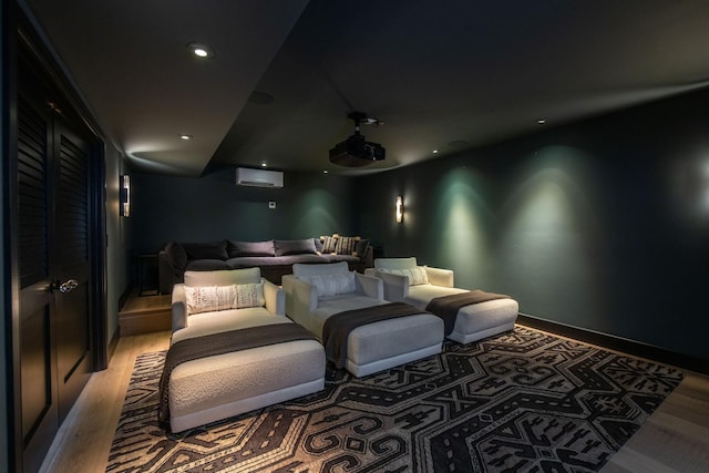 home theater featuring wood-type flooring and an AC wall unit