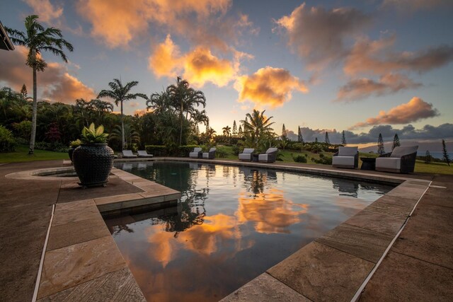 view of pool at dusk