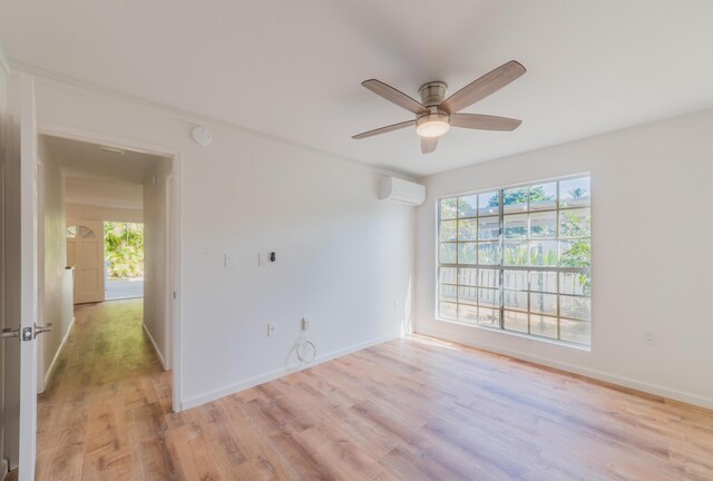 160 Keonekai Rd Unit 9-102, Kihei, HI 96753 - empty room featuring ceiling fan, light wood-type flooring, and a wall unit AC