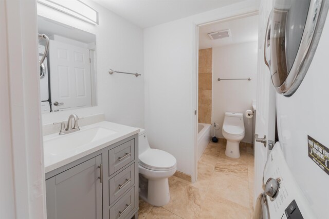 160 Keonekai Rd Unit 9-102, Kihei, HI 96753 - full bathroom featuring vanity, tile patterned floors, tiled shower / bath, toilet, and stacked washer / dryer