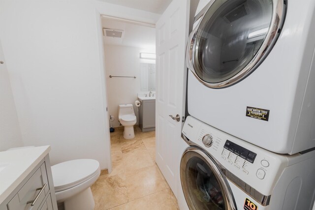 160 Keonekai Rd Unit 9-102, Kihei, HI 96753 - laundry area featuring stacked washer / dryer and light tile patterned floors