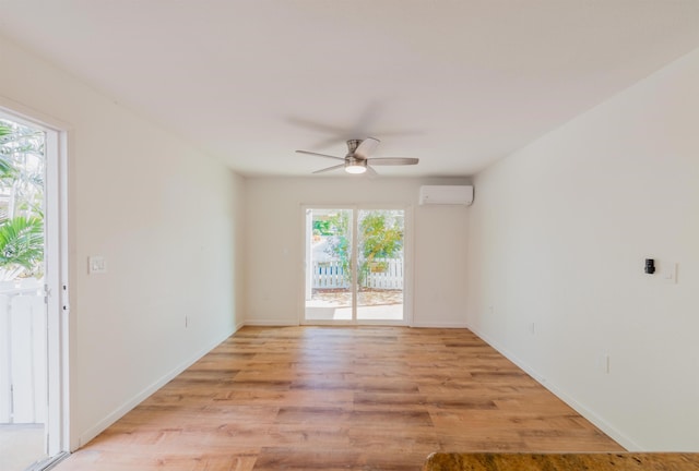 160 Keonekai Rd Unit 9-102, Kihei, HI 96753 - empty room featuring a wall mounted AC, ceiling fan, a healthy amount of sunlight, and light hardwood / wood-style floors