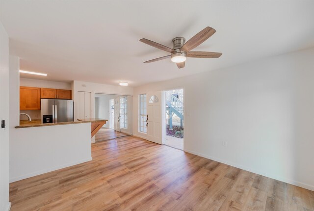 160 Keonekai Rd Unit 9-102, Kihei, HI 96753 - unfurnished living room with light wood-type flooring and ceiling fan
