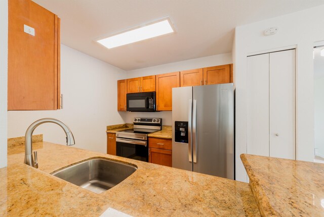 160 Keonekai Rd Unit 9-102, Kihei, HI 96753 - kitchen featuring light stone countertops, sink, and appliances with stainless steel finishes