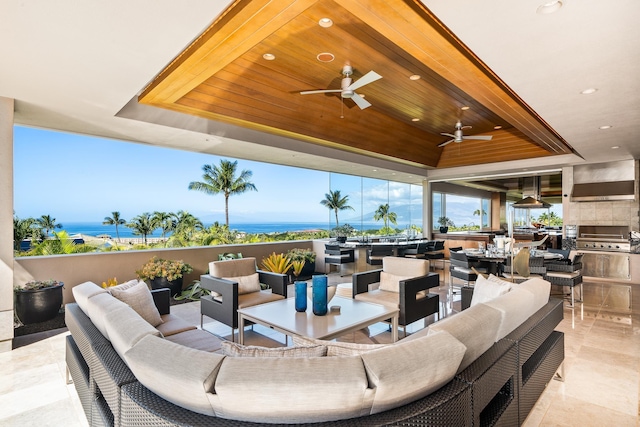 view of patio with outdoor lounge area, a water view, and grilling area