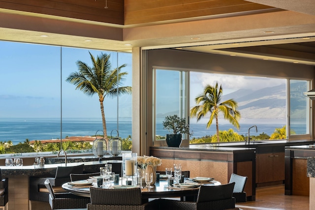 dining space featuring a water view and wood finished floors