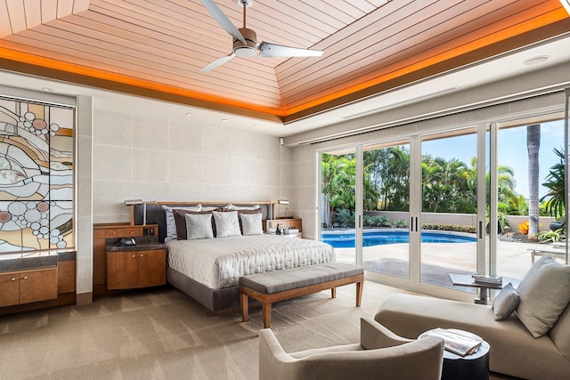 bedroom with access to exterior, light colored carpet, wooden ceiling, and multiple windows