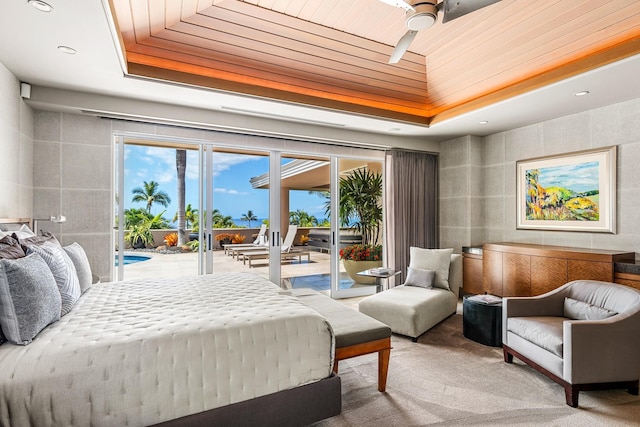 carpeted bedroom featuring wooden ceiling, access to exterior, and a raised ceiling