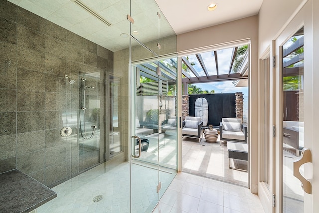 bathroom featuring tiled shower, visible vents, and tile patterned floors