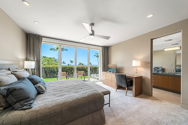 bedroom with light carpet, access to outside, a sink, and recessed lighting