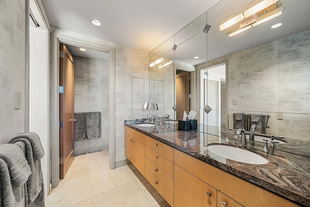 full bathroom featuring double vanity, a sink, and recessed lighting