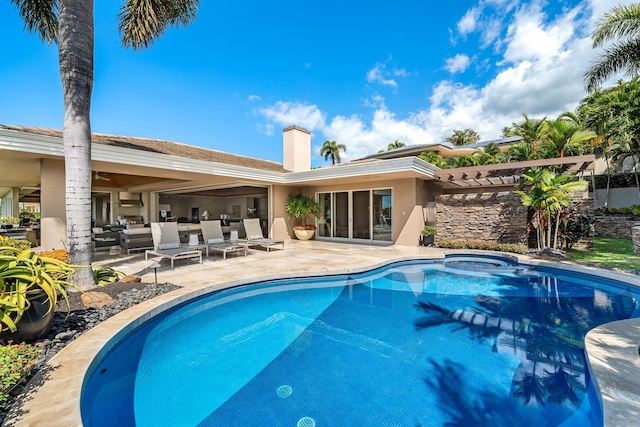 pool with a hot tub, a patio area, and outdoor lounge area