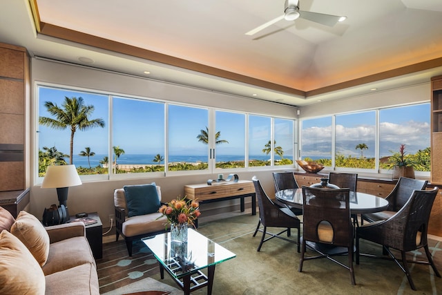 sunroom / solarium featuring lofted ceiling and ceiling fan