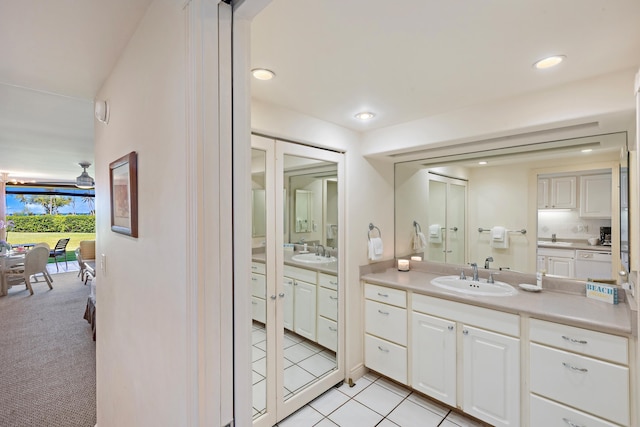 full bathroom with a sink, two vanities, recessed lighting, and tile patterned flooring