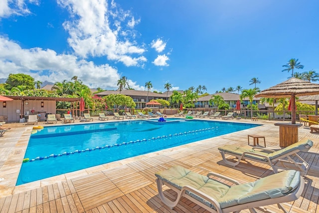 community pool with a patio and fence