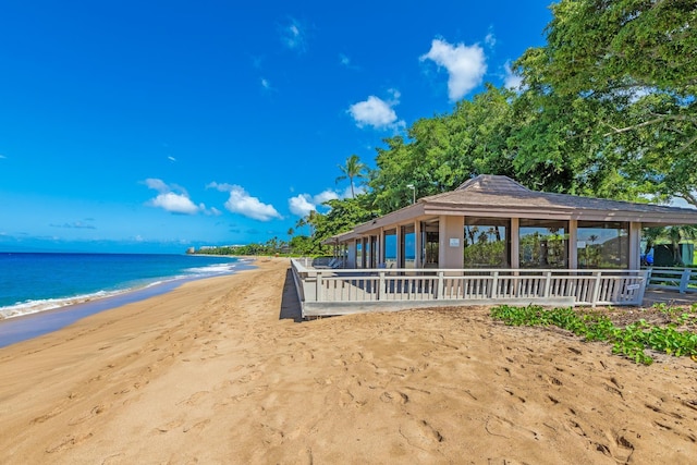 surrounding community featuring a gazebo, a view of the beach, and a water view