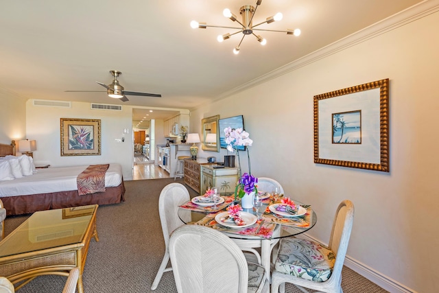 carpeted dining room featuring visible vents, baseboards, and ornamental molding