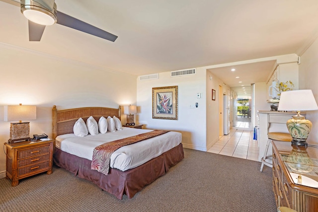 bedroom featuring visible vents, light colored carpet, crown molding, and ceiling fan