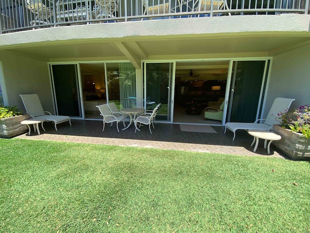 exterior space featuring a balcony and a yard