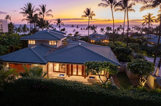 view of front of property with a water view