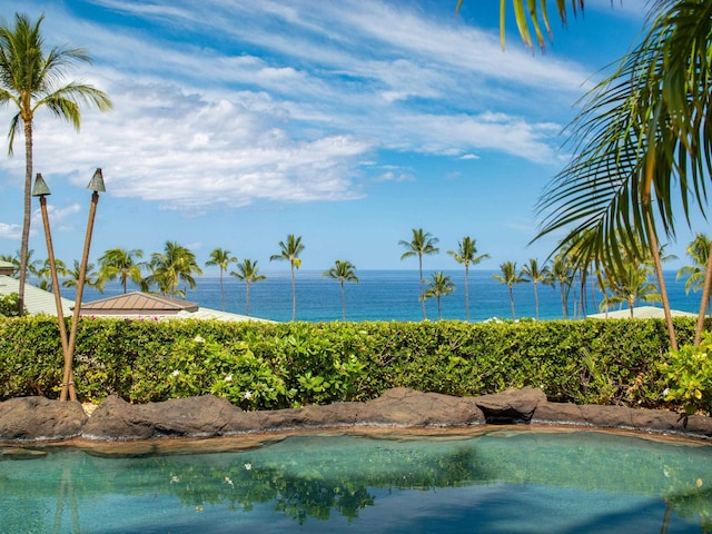 view of swimming pool with a water view