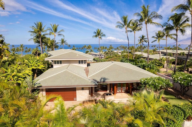 view of front of property featuring a water view and a garage