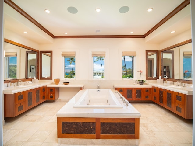 bathroom with vanity, ornamental molding, a bathtub, and tile patterned floors