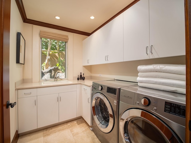 laundry room with washing machine and dryer, sink, cabinets, crown molding, and light tile patterned flooring