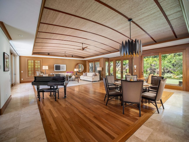 tiled dining space with ceiling fan and french doors