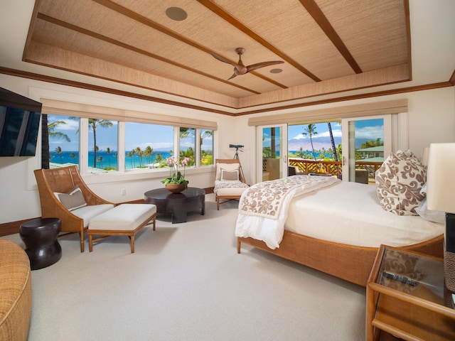 bedroom featuring carpet floors, a water view, ceiling fan, and a raised ceiling