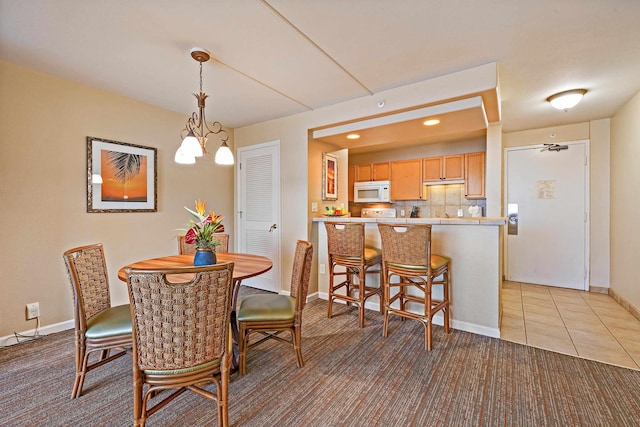 4327 Lower Honoapiilani Rd Unit 1002B, Lahaina, HI 96761 - dining space with light carpet and baseboards