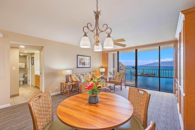 4327 Lower Honoapiilani Rd Unit 1002B, Lahaina, HI 96761 - dining area with floor to ceiling windows, baseboards, light tile patterned floors, a ceiling fan, and light colored carpet