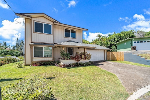 traditional-style house featuring driveway, an attached garage, a front lawn, and fence