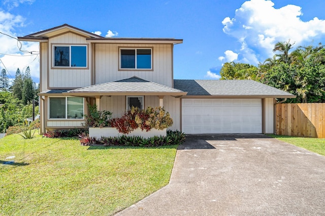 view of front of property with driveway, a front lawn, fence, roof with shingles, and an attached garage