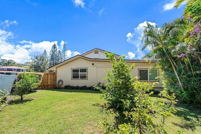 exterior space with a lawn and fence