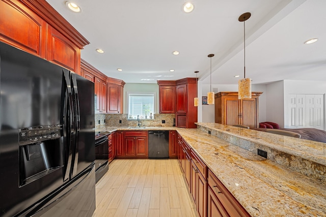 kitchen with decorative backsplash, black appliances, decorative light fixtures, and light stone countertops