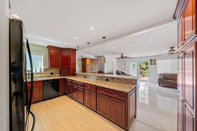 kitchen with open floor plan, a peninsula, black appliances, a ceiling fan, and reddish brown cabinets