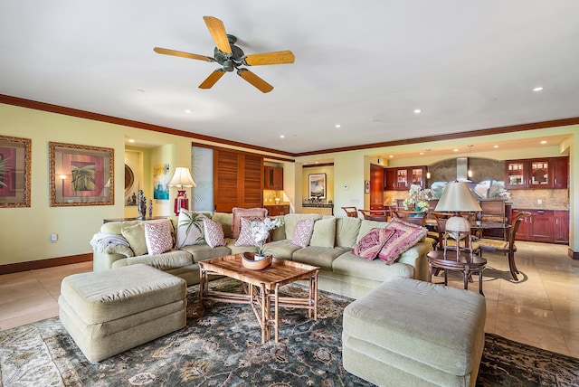 living room with tile patterned floors, ceiling fan, and ornamental molding