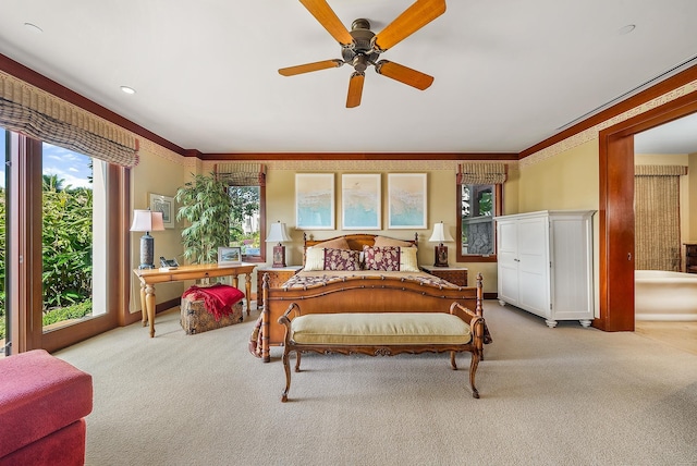 bedroom featuring ceiling fan, crown molding, and light colored carpet