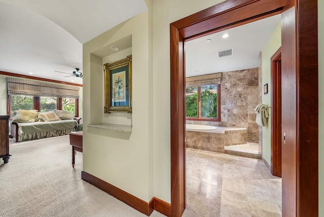 hallway featuring light colored carpet