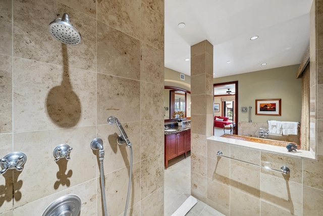 bathroom featuring tiled shower, vanity, and tile patterned floors