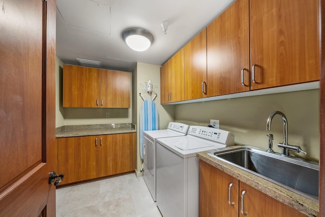 laundry area with washer and clothes dryer, cabinets, and sink