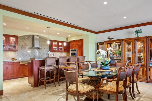 dining space with crown molding, light tile patterned flooring, and wet bar